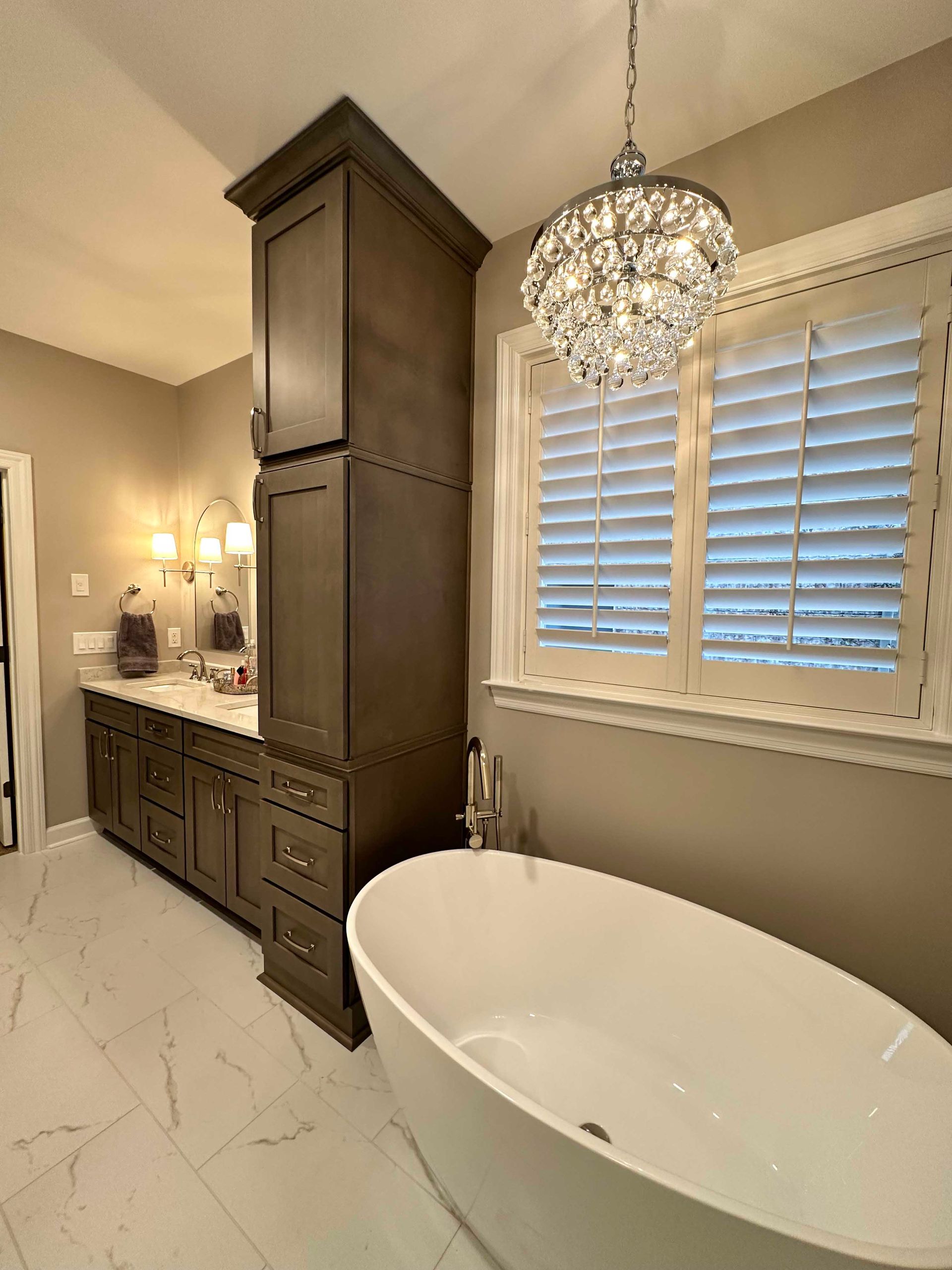 Bathroom with freestanding tub and dark vanity